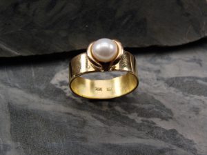 A gold ring with a pearl