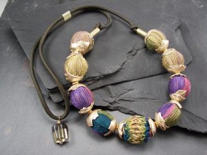 A bracelet with gold, purple, and blue beads