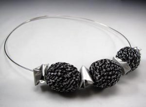 A silver bracelet with three beads