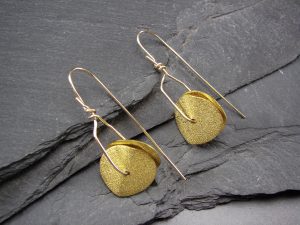 A pair of gold earrings