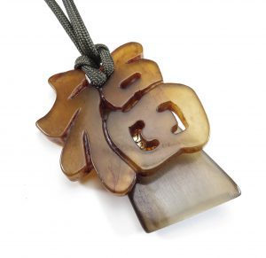 A light yellow pendant with special characters