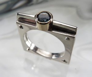 A square ring with a clear gem