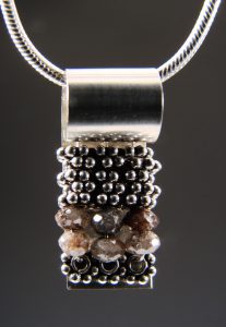 A pendant with small silver beads