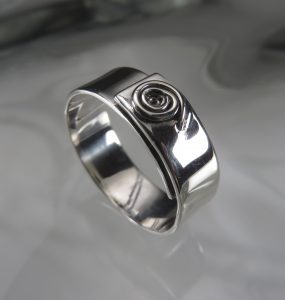 A silver ring with a spiral design