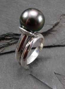 A silver ring with a pearl