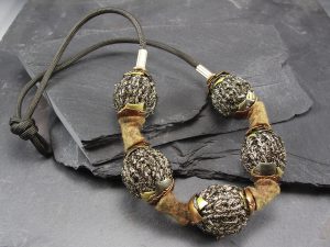 A bracelet with wool and silver beads
