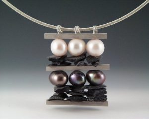 A pendant with silver beads and pearls